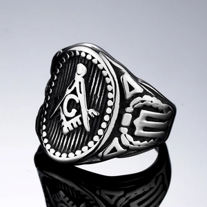 Macro shot of vintage Masonic steel ring featuring compass and square G symbol