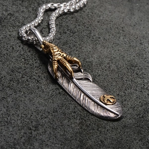 Vintage oxidized stainless steel feather pendant necklace with golden eagle claw detail