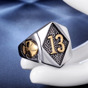 Macro detail of gothic skull ring with golden number 13 on hexagonal stainless steel face
