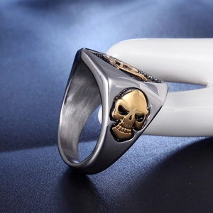 Mens stainless steel skull ring with punk gold embossed finish on brushed metal band