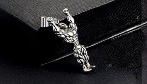 Macro shot of a silver fitness muscular man pendant showing detailed back muscle textures
