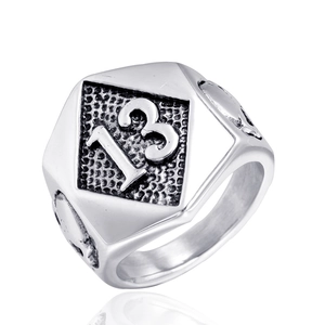 Close-up of stainless steel biker ring featuring a number 13 on hexagonal face and skull sides