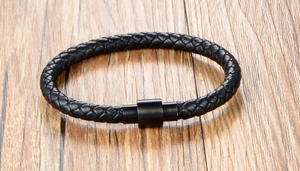 Close-up of black braided leather bracelet with matte black magnetic metal clasp