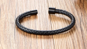 Close-up of black braided leather bracelet with a matte black magnetic metal clasp