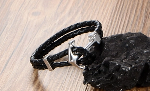 Close-up of double-layer black braided leather bracelet with a polished silver anchor clasp