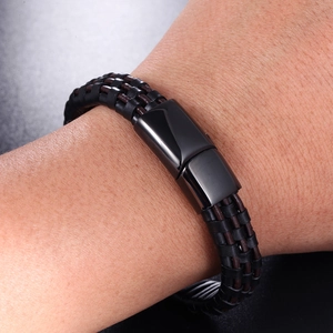 Close-up of woven leather men's bracelet with industrial black metal magnetic clasp