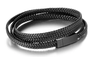 Detail of multi-layer black braided leather bracelet with matte metal magnetic clasp