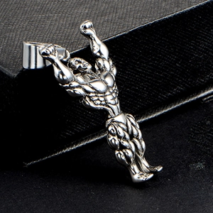 Polished silver muscle man pendant in bodybuilder pose on a black textured box