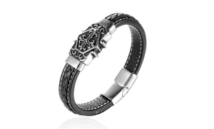 Close-up of black braided leather bracelet with vintage silver metal cross buckle detail