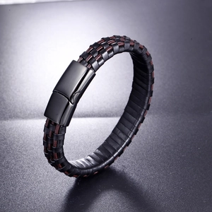 Braided leather bracelet for men with black magnetic clasp in dark professional photography