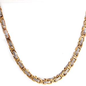 Macro detail of bicolor gold and silver Byzantine square link chain in 316L stainless steel