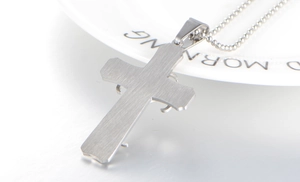 Detailed view of the brushed metal finish on the silver cross pendant back and bead chain