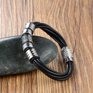 Men's woven leather bracelet with vintage scroll-pattern metal beads on pebbles