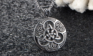 Macro view of vintage stainless steel Celtic knot pendant with intricate engraved textures