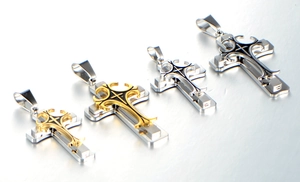 Detailed view of layered gothic cross pendants in gold and silver stainless steel finish