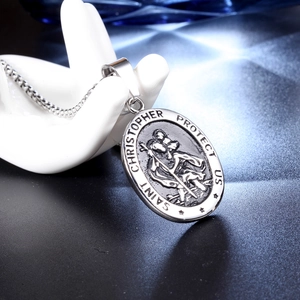 Oval Saint Christopher pendant necklace in silver stainless steel on jewelry display