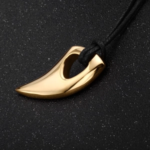 Golden horn pendant necklace for men with black rope cord on starry textured background