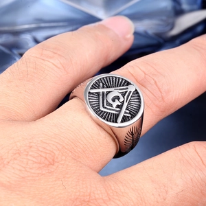 Macro view of Masonic G symbol and compass engraving on polished stainless steel men's ring