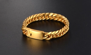 Macro detail of golden Cuban link chain bracelet with rectangular secure clasp