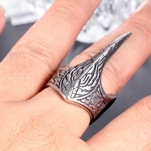 Detail of vintage punk eagle beak ring with engraved gothic textures on stainless steel