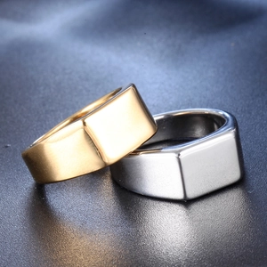 Macro shot of rectangular signet rings in gold and silver polished stainless steel