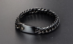 Macro shot of polished black stainless steel curb chain bracelet with secure buckle