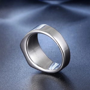 Macro shot of minimalist silver stainless steel wide ring with asymmetric polished surface
