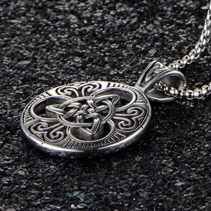 Celtic Triquetra knot round stainless steel pendant with intricate scrollwork on box chain