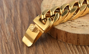 Gros plan d'un bracelet gourmette en or poli avec détail du fermoir sur bois