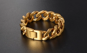 Detail of gold Cuban link bracelet with brushed metal texture and folding clasp for men
