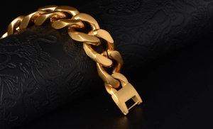 Detail of gold Cuban link bracelet with matte brushed finish and secure clasp