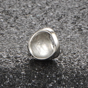 Detailed view of wide titanium steel ring with textured surface and polished inner band