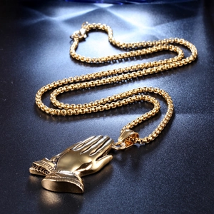 Detailed view of golden praying hands pendant with box chain and secure lobster clasp