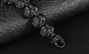 Macro shot of 316L stainless steel skull link bracelet in matte black with dragon scroll
