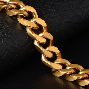 Polished gold-plated Cuban link chain for men on a black textured leather background