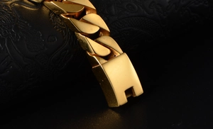 Detailed close-up of polished golden cuban link chain with a secure square box clasp
