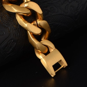 Men's gold plated thick Cuban link bracelet with a matte finish and square metal clasp