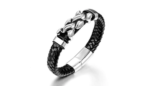 Macro shot of a braided black leather men's bracelet with a polished silver metal flame charm
