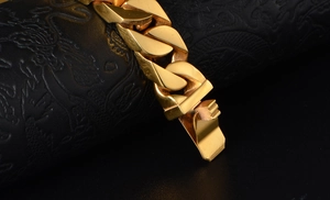 Macro detail of a chunky golden Cuban link chain featuring high-polish finish and clasp