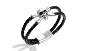 Close-up of black braided leather bracelet with silver skull charm and magnetic clasp