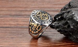 Macro detail of silver stainless steel US Navy signet ring with gold embossed anchor patterns