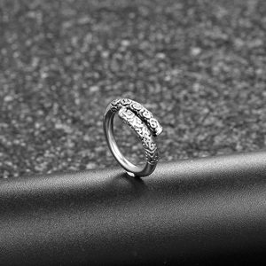 Vintage style open ring featuring silver metal material and traditional relief patterns