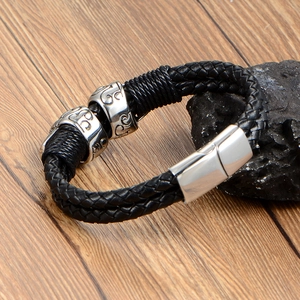 Punk woven black leather bracelet for men with double silver skull charms and metal clasp