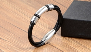 Close-up of multilayer black leather bracelet with silver steel accents and magnetic clasp