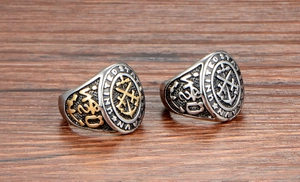 Detailed close-up of retro US Navy titanium steel rings on a rustic wooden surface