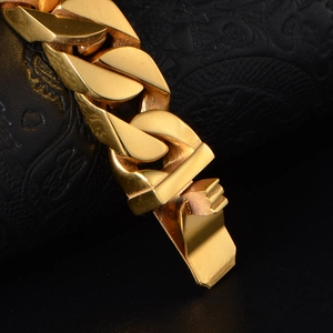 Polished gold curb chain bracelet in stainless steel with secure fold-over clasp
