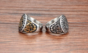Detailed view of retro United States Navy steel rings with anchor emblems and embossing