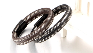 Detailed macro of woven leather cords with rectangle magnetic clasps in black and brown
