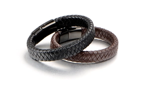 Detail of minimalist black and dark brown braided leather bracelets with metal clasps