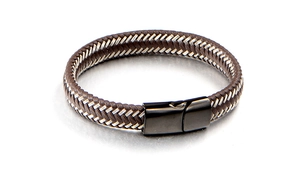 Detail of brown woven leather cord bracelet with silver wire and black magnetic buckle